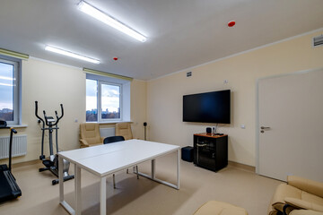 relaxation room with chairs and exercise equipment in office for rest and relax of staff