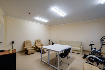 relaxation room with chairs and exercise equipment in office for rest and relax of staff