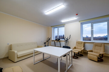 Fototapeta na wymiar relaxation room with chairs and exercise equipment in office for rest and relax of staff
