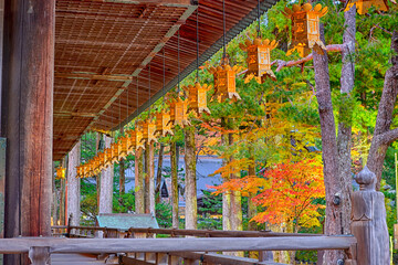 Japan Religious Ideas. Seasonal Red Maples and Pond With Lantern on Sacred Mount Koyasan in Japan.