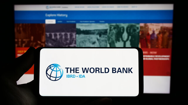 Stuttgart, Germany - 04-02-2023: Person holding smartphone with logo of financial institution The World Bank on screen in front of website. Focus on phone display.