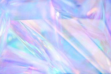 Close-up of ethereal pastel neon blue, purple, lavender, mint holographic metallic foil background....