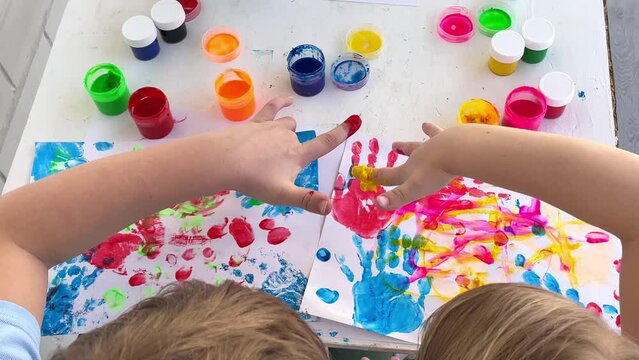 Children paint fingers drawing baby painting hand therapy children art play. Kids have fun and create picture. Palms of different colors. Sensory development and experiences, themed activities with ch