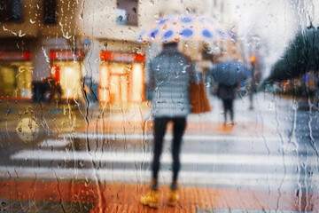  people with an umbrella in rainy days in winter season, bilbao, basque country, spain