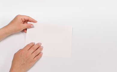 Fototapeta premium a white sheet of paper in your hands for your text.