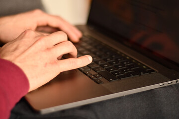 Fototapeta na wymiar Hands typing on the keyboard of a notebook