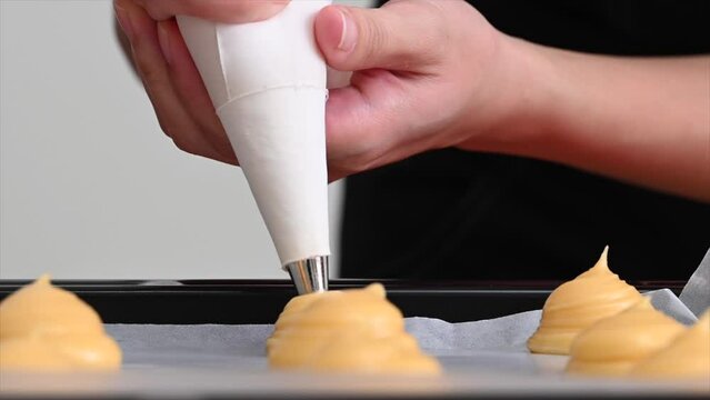 Making sweets, squeezing the choux pastry