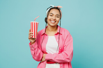 Young woman of African American ethnicity wear pink shirt white t-shirt headscarf look camera hold...