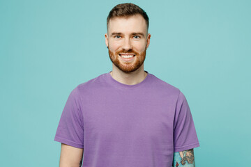 Young smiling happy stylish cool caucasian european bearded unshaven man he wear purple t-shirt...