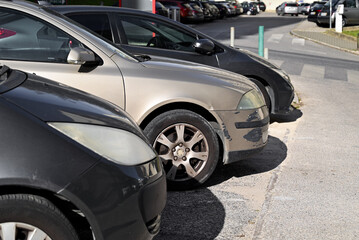 Obraz na płótnie Canvas A scratched car is parked in the parking lot.The process of arranging car insurance.