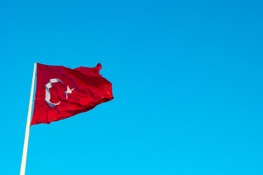 Turkish Flag isolated on blue sky background with copy space for text.