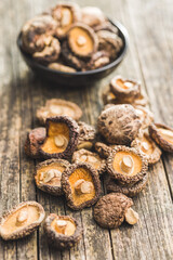 Dried shiitake mushrooms on wooden table.