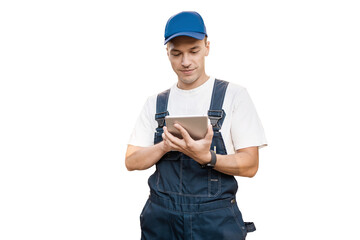 A male employee of a construction company in an engineer's uniform uses a tablet, transparent...