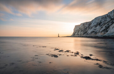 Obraz premium Sunset and low tide at Beachy Head lighthouse south downs on the east Sussex coast south east England