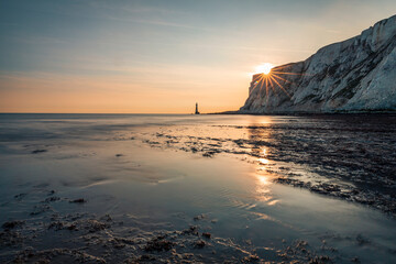 Sunset and low tide at Beachy Head lighthouse south downs on the east Sussex coast south east England