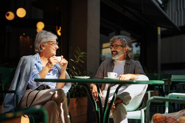 Fototapeta premium Mature couple drink coffee outdoors.