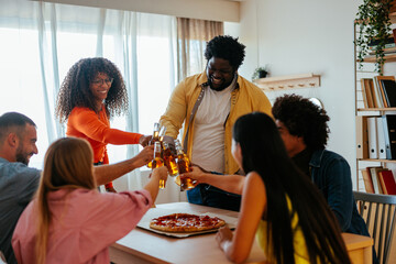 Friends toasting with beer at home