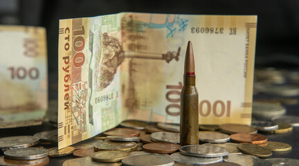 Bullet and Russian banknote on a pile of coins, symbol of Sevastopol, occupation of Ukraine