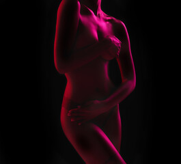 Neon, seductive and the body of a woman in the dark isolated on a black background in a studio. Sexy, art and a girl covering with a purple glow for creativity, mystery and artistic on a backdrop