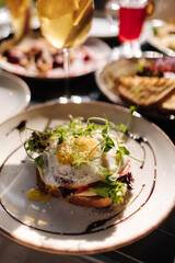 Delicious breakfast in restaurant. Toast with egg on the top
