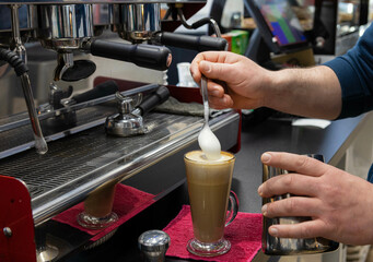 Adding cream to coffee