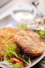 Fried grated potatoes served with mushroom sauce and sour cream. Tasty Ukrainian dish