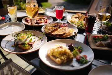 Served table with food and drinks. Restaurant on terrace. 