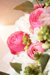 A bouquet of flowers, roses, white carnations, greenery close-up. Floral background, front view