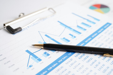 Pen on chart or graph paper. Financial, account, statistics and business data concept.