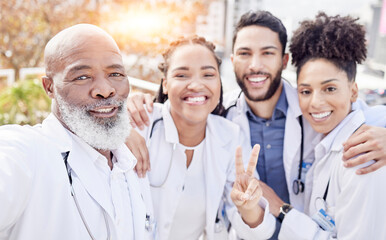 Selfie, peace and collaboration with a team of doctors posing outdoor together while working at a hospital. Profile picture, healthcare and medical with a group of friends taking a photograph outside