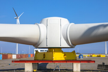 Giant rotors of wind turbine under blue sky