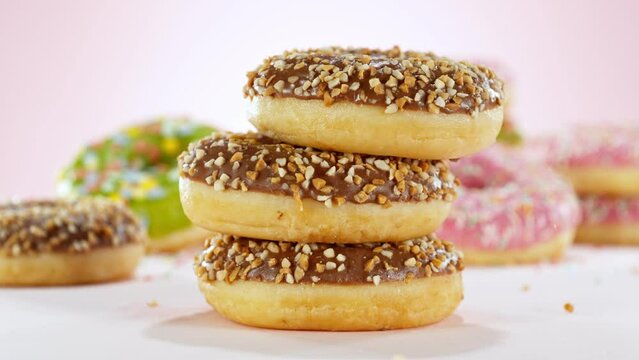 Super slow motion of stacking sweet donuts pieces. Camera in motion. Filmed on high speed cinema camera, 1000 fps. Placed on high speed cine bot. Speed ramp effect.