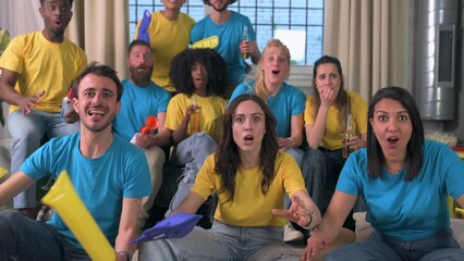 Fans of a sports team in front of the television follow the course of the competition with expectations and tension, but the team fails and people getting sad - Powered by Adobe