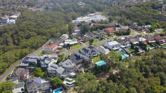 Aerial drone pullback reverse view of Barden Ridge in the Sutherland Shire, Sydney NSW showing Woronora River on a sunny day  