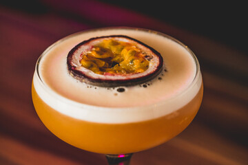 Closeup of a pornstar martini cocktail with a passion fruit