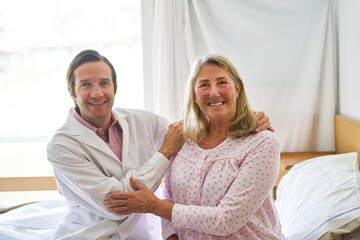 Smiling doctor with elderly woman at rehab center