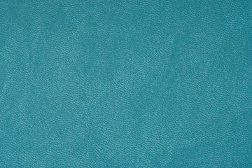 Green faux leather background close up.