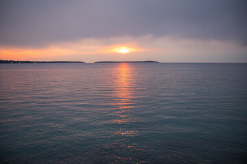 Sunset over Adriatic Sea with golden dramatic sky panorama. Fazana, Istria, Croatia.