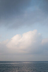 Naklejka na ściany i meble View on white clouds over sea in calm weather 