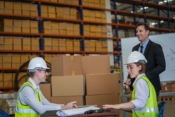 Warehouse managers and worker working together in warehouse office in a large distribution warehouse,Logistic industry concept.