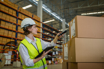 Worker scanning parcels for retail and transport shipping in warehouse stock checking,Supervisor team control and management,Logistics warehouse people.