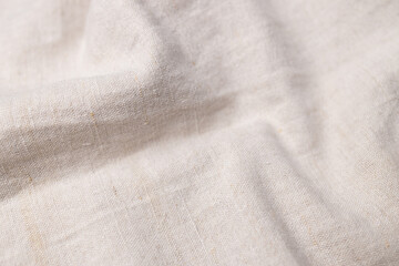 Fototapeta na wymiar Natural linen fabric texture. Rough crumpled burlap background. Selective focus