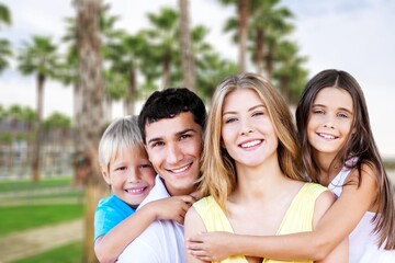 Happy young family having fun in vacation on beach