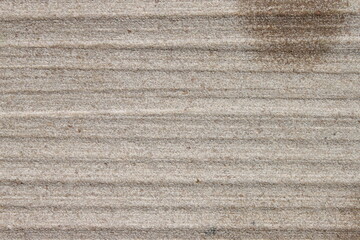 Close up of reddish sandstone surface with lines on it