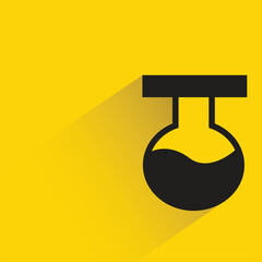 lab flask with shadow on yellow background