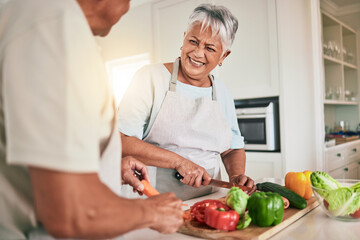Fototapeta na wymiar Cooking vegetables, kitchen and senior couple cutting ingredients, prepare food and smile on romantic home date. Health nutritionist, culinary and hungry man, woman or people bonding over lunch meal