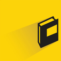 book with shadow on yellow background