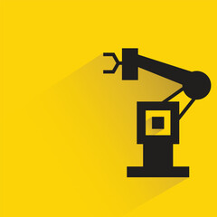 industrial robotic arm with shadow on yellow background