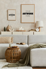 Stylish interior of living room with design sofa, two wooden mock up frames, decorations, coffee table and personal accessories. Home decor. Template. 