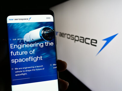 Stuttgart, Germany - 04-02-2023: Person holding smartphone with web page of company Isar Aerospace Technologies GmbH on screen in front of logo. Focus on center of phone display.